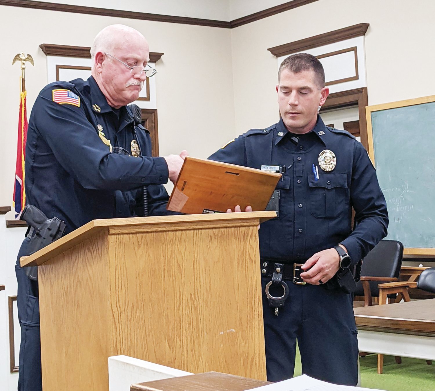 Sparta Police Chief Doug Goff presents the Officer of the Year Award to Brandon Starkey, a member of Sparta Police Department.